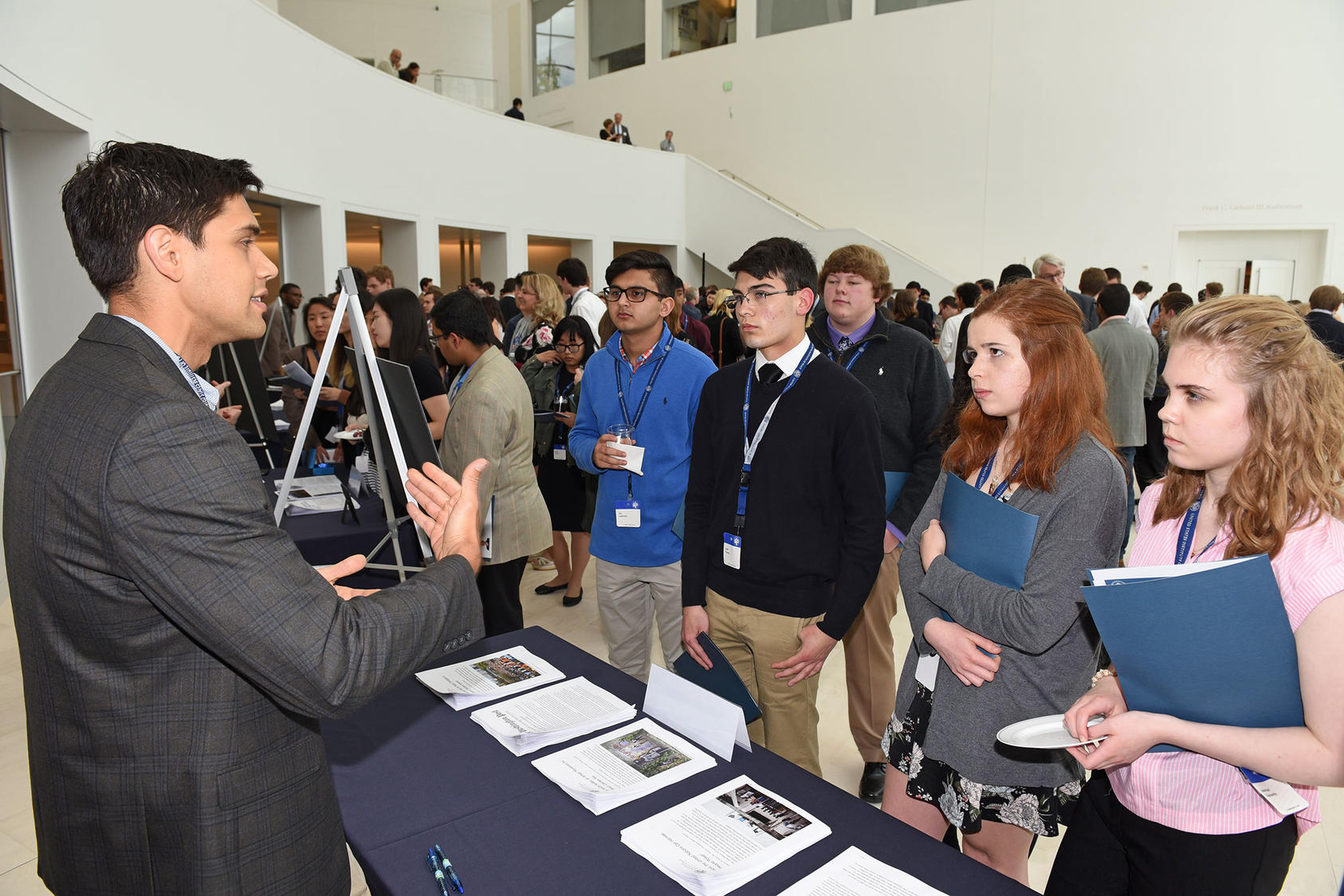 USIP staff engage with an audience of students, teachers, and parents from 25 U.S. states at the 2018 national competition reception for Academic WorldQuest, a program of the World Affairs Councils of America, which USIP sponsors.