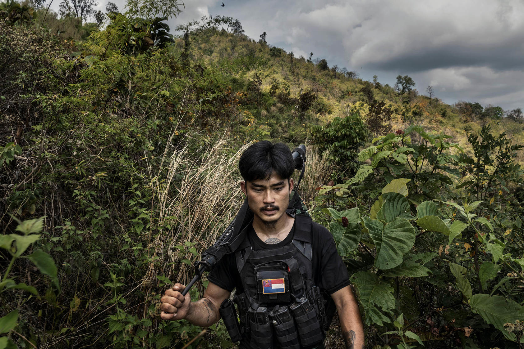 A member of an ethnic militia patrols a front line area near government military positions in the Kayin State of Myanmar, March 9, 2022. (Adam Dean/The New York Times)